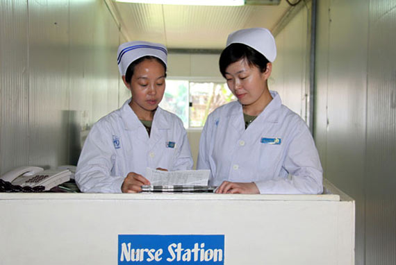 圖為護(hù)士長(zhǎng)高翠玲(左)和護(hù)士孫艷傳授護(hù)理技巧。